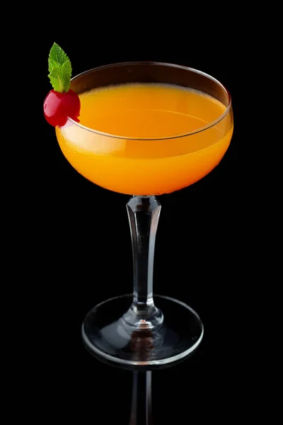 Orange alcohol cocktail with mint and cherry isolated on black — Stock Photo, Image