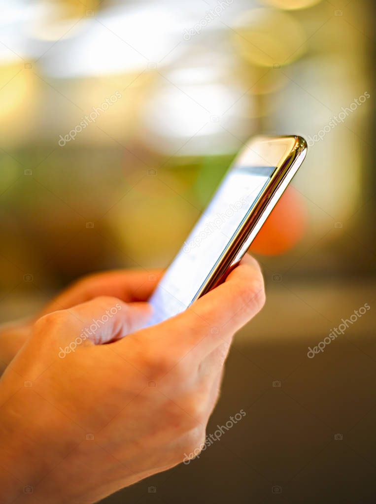 Close up image of female hands using smartphone at night street