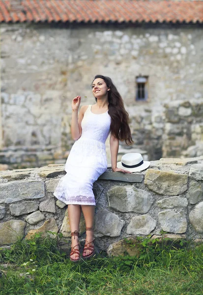 Stylish Brunette Woman White Dress Background Brick Wall Holding Hat — Stock Photo, Image