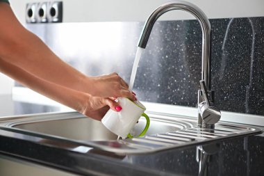 Mutfakta bulaşık kadının ellerini yukarıya kapatmak