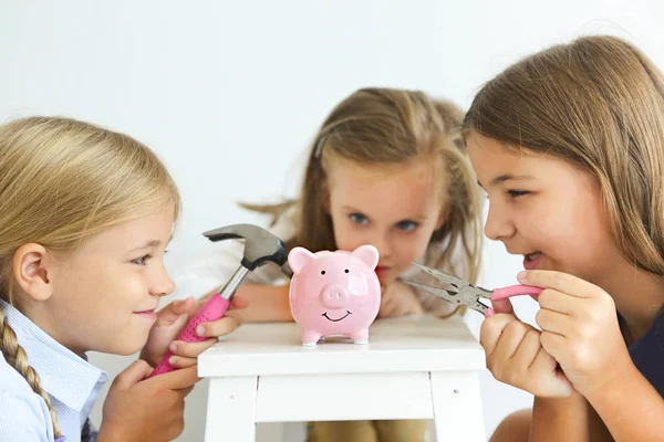 ドライバー ペンチ 白地にピンクのブタ貯金箱銀行によってハンマーの子どもたち — ストック写真