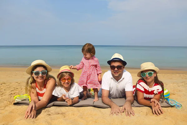 Family of five on the beach. Travel and family vacation concep