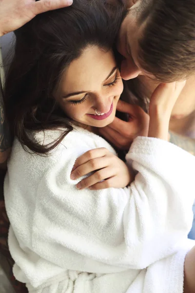 Sexy couple smiling while lying on bed together — Stock Photo, Image