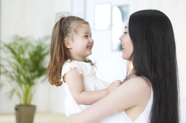 Lycklig ung ljus mamma kramar hennes lilla dotter — Stockfoto