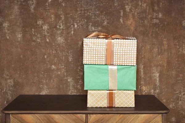 Stack of handcraft gift boxes on wooden board with a natural tex — Stock Photo, Image
