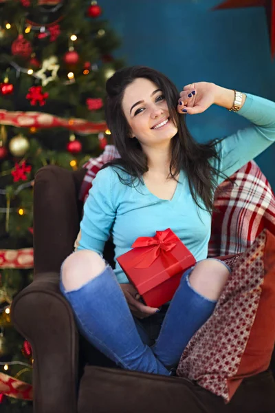 Mujer feliz sonriente con caja de regalo sobre la sala de estar en Navidad —  Fotos de Stock