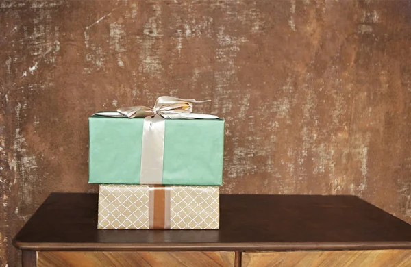 Stack of handcraft gift boxes on wooden board with a natural tex — Stock Photo, Image