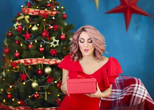 Smiling happy woman with gift box over living room on Christmas — Stock Photo, Image