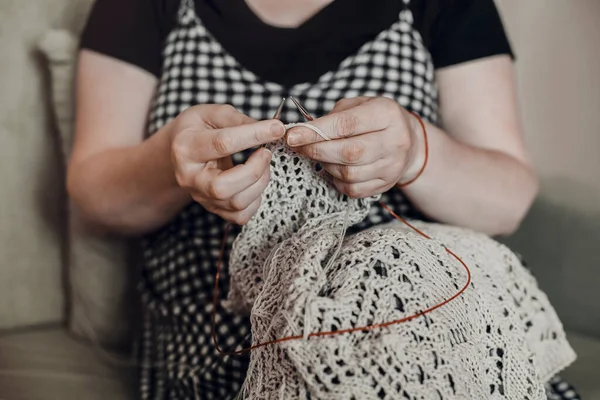 坐在沙发上做手工针织品的难认作物女工匠 — 图库照片