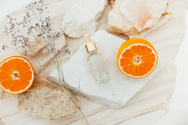 Glass Bottle Facial Serum Arranged Table Stones Ripe Oranges — Stock Photo, Image