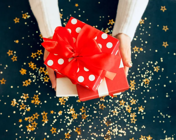 Anonymous Female Wrapped Present Decorated Red Ribbon Placed Navy Blue — Stock Photo, Image