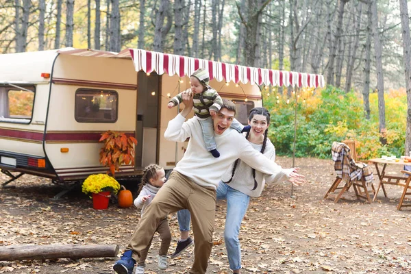 Portrait Young Smiling Family While Hugging House Wheels Outdoors — Stock Photo, Image