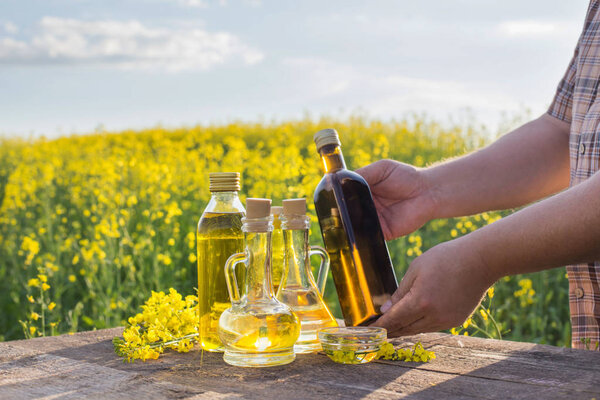 rapeseed oil on wooden table in field