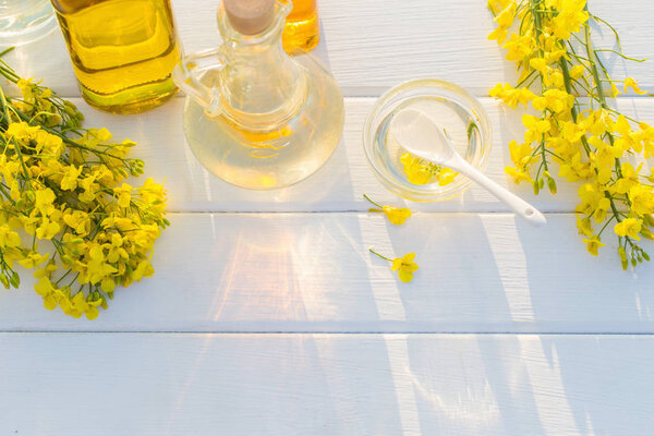rapeseed oil on wooden table in field