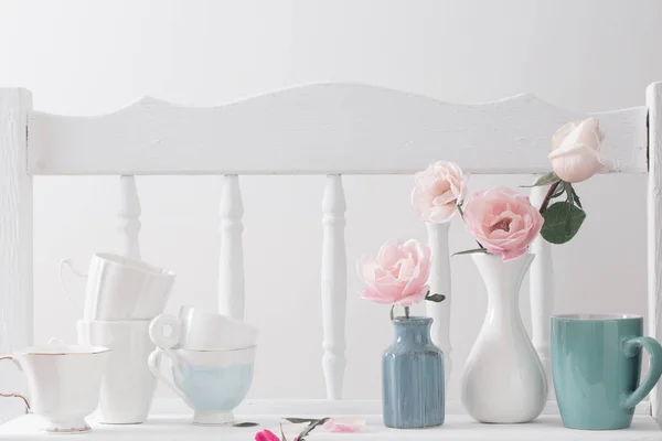 pink roses on vintage wooden white shelf