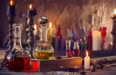 Magic potion, ancient books and candles clipart