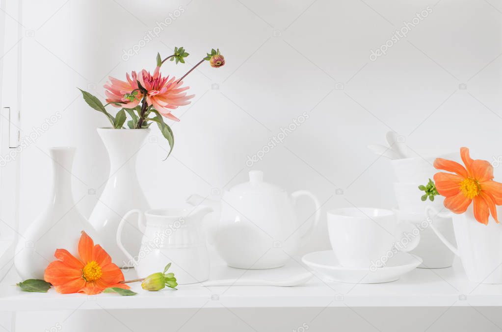 white dishvare with flowers on wooden shelf
