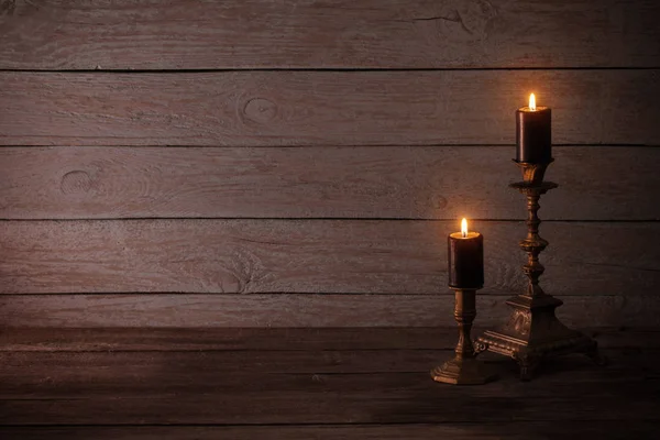 Black Burning Candles Candlesticks Old Wooden Background — Stock Photo, Image