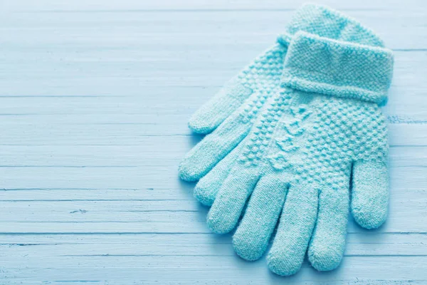 blue gloves on blue wooden background