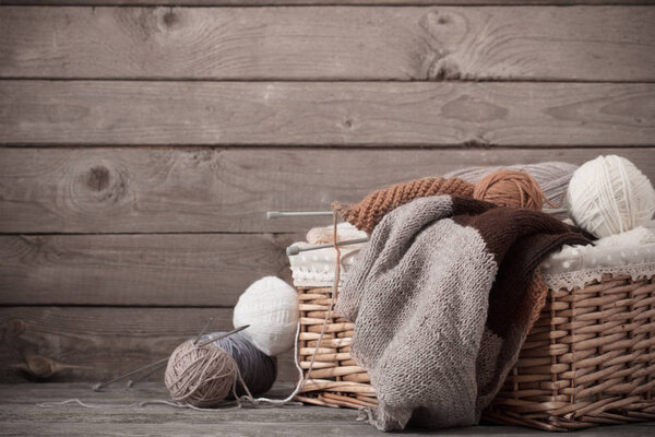 Knitting and knitting needles on a wooden surface
