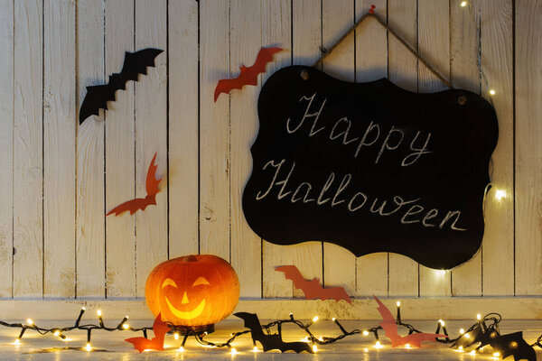Halloween decorations on wooden background in home
