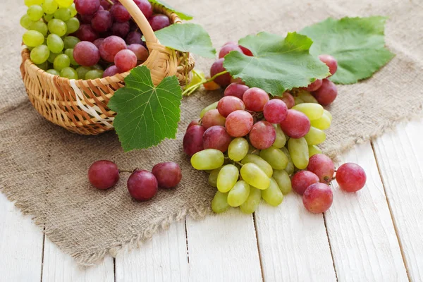 粉红色和绿色的葡萄在木质背景下 — 图库照片