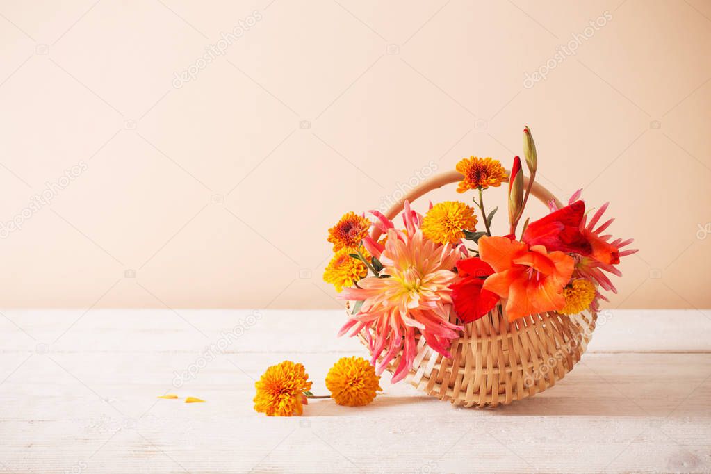 summer flowers in basket on wooden table