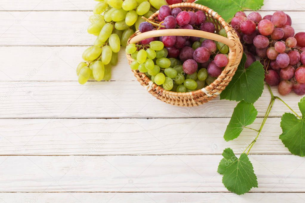 pink and green grape on wooden background