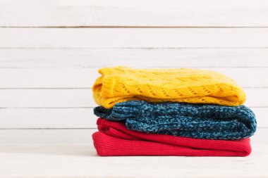 Beyaz ahşap zemin üzerine örme kazak