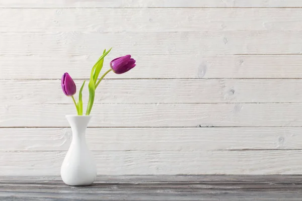 Spring flowers in white vase — Stock Photo, Image