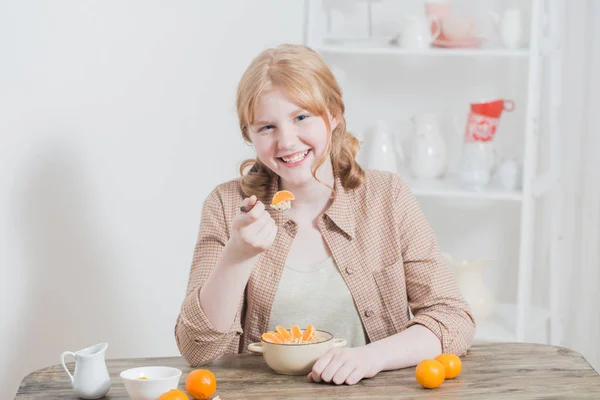 Tiener meisje en gezond ontbijt met havermout en mandarijnen — Stockfoto