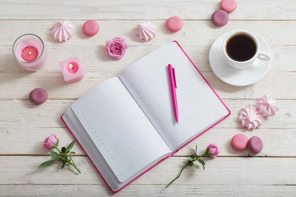 Notebook met kopje koffie op witte houten tafel — Stockfoto