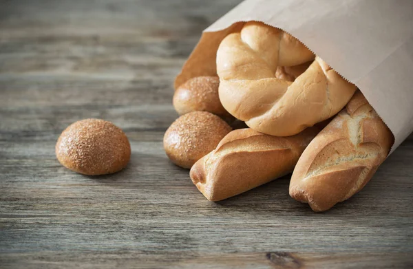 Baguette on old wooden background — Stock Photo, Image