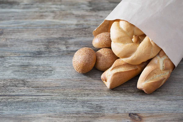 Baguette on old wooden background — Stock Photo, Image