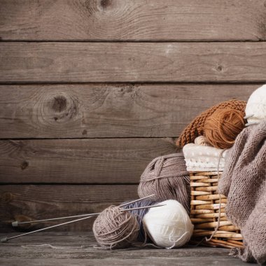 Örgü ve örgü iğneleri bir ahşap yüzeye