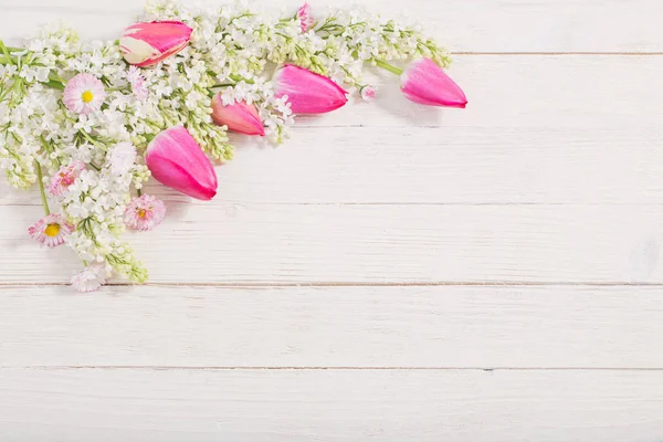 Spring flowers on white wooden background — Stock Photo, Image