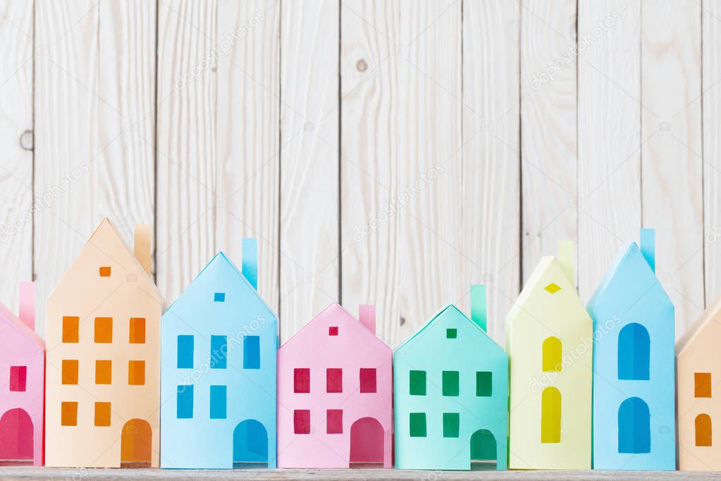 paper houses on wooden background