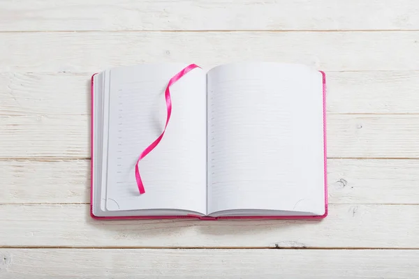 Notebook on white wooden background — Stock Photo, Image