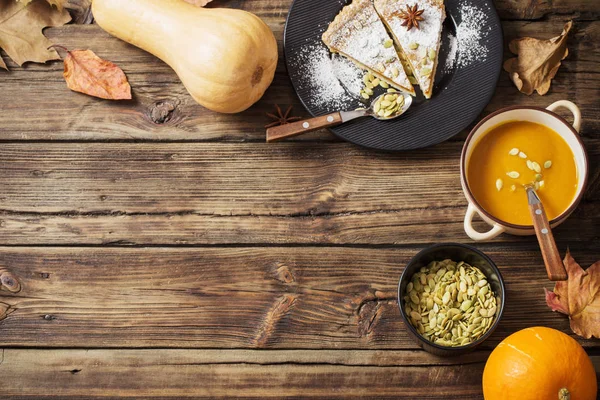 Pumpkin dishes on wooden background — Stock Photo, Image