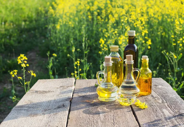 rapeseed oil on wooden table in field