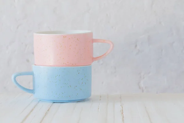 Modern ceramic cups on background white wall — Stock Photo, Image