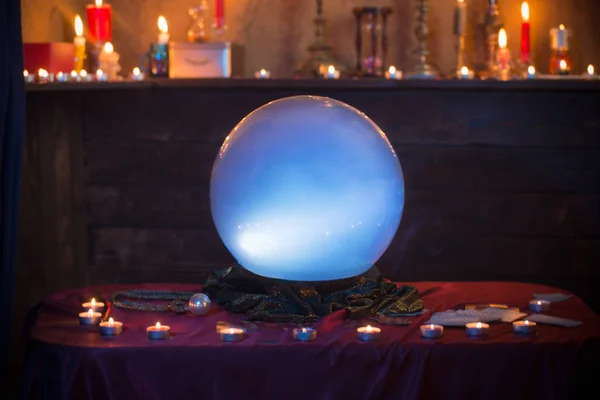 Magic crystal ball with burning candles on  table — Stock Photo, Image