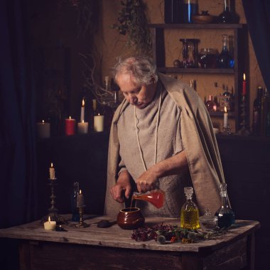 elderly alchemist monk brews  magic potion clipart