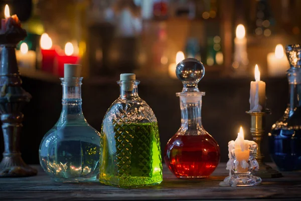 Magic potions in bottles on wooden background — Stock Photo, Image