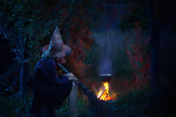 Young witch by  fire in night forest — Stock Photo, Image