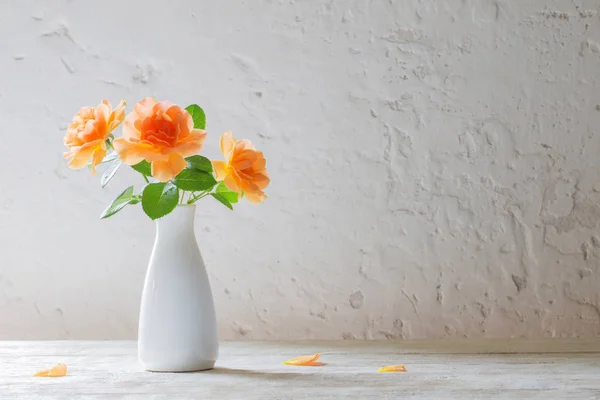 Rosas em vaso no fundo parede branca — Fotografia de Stock