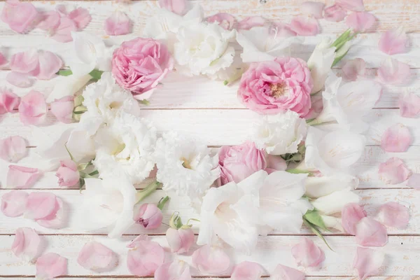 pink and white flowers on white wooden background