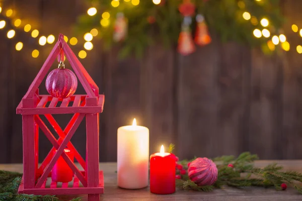 Lanterna de madeira com velas e ramos de Natal em costas de madeira — Fotografia de Stock