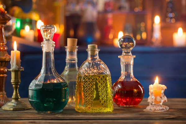 Magic potions in bottles on wooden background — Stock Photo, Image