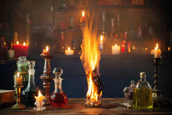 Old burning paper with potions on old wooden table — Stock Photo, Image